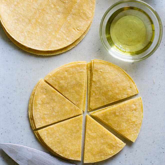 Bake your own Homemade Tortilla Chips in 10 minutes! Extra thin tortillas ensure crunchy snacks every time, perfect for salsa and guacamole.