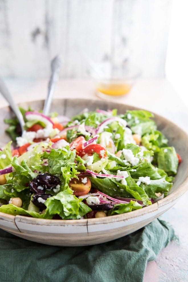 Mediterranean chopped salad in a large wooden serving bowl.