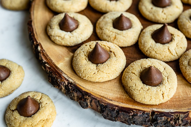 An easy Peanut Butter Blossoms cookie recipe. Soft, chewy peanut butter cookies are rolled in sugar, baked, and topped with a single Hershey's kiss!