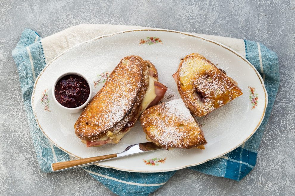 An overhead shot of a monte cristo sandwich on a white platter.