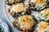 Stuffed portobello mushrooms on a white platter.