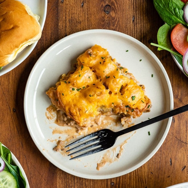 Cowboy casserole on a white plate with a silver fork.