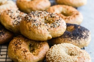 Homemade bagels on a cooling rack.
