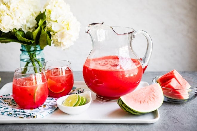 A pitcher of agua fresca on a serving platter.