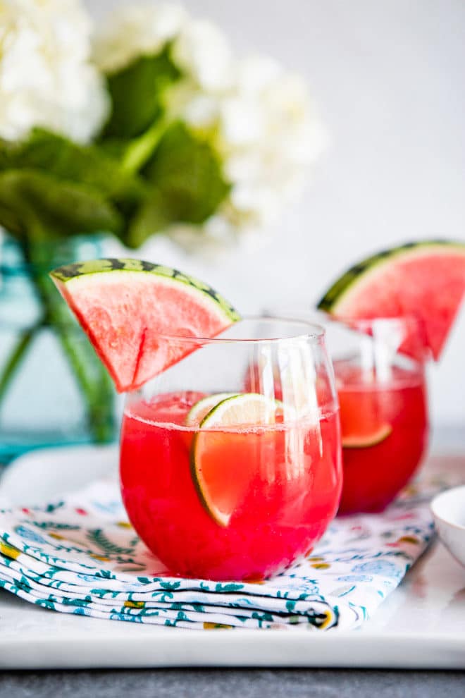 Two glasses of agua fresca on a serving platter.