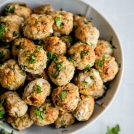 Turkey meatballs in a white serving bowl.