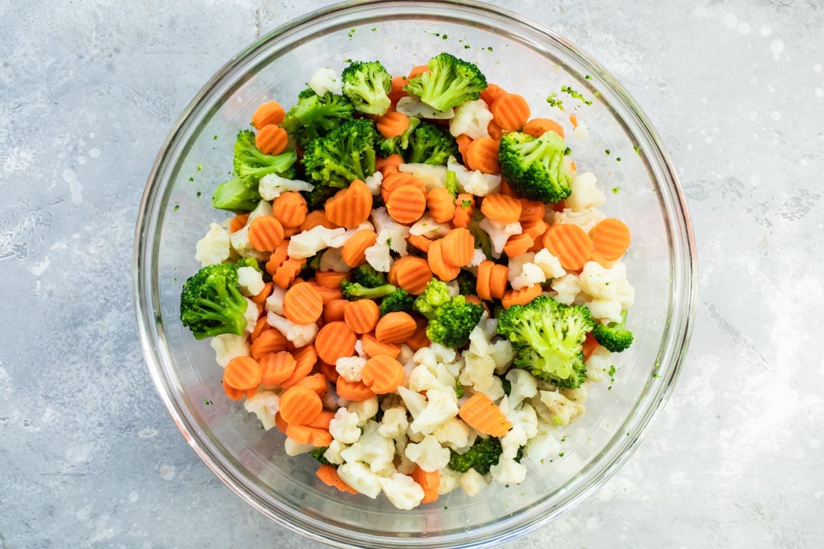 Frozen vegetables in a glass bowl.