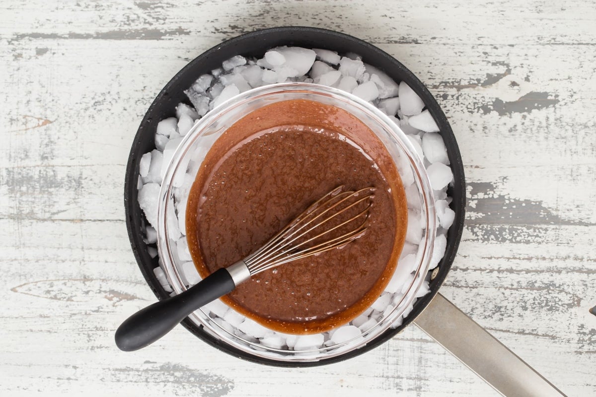 A bowl of chocolate mousse chilling over ice.
