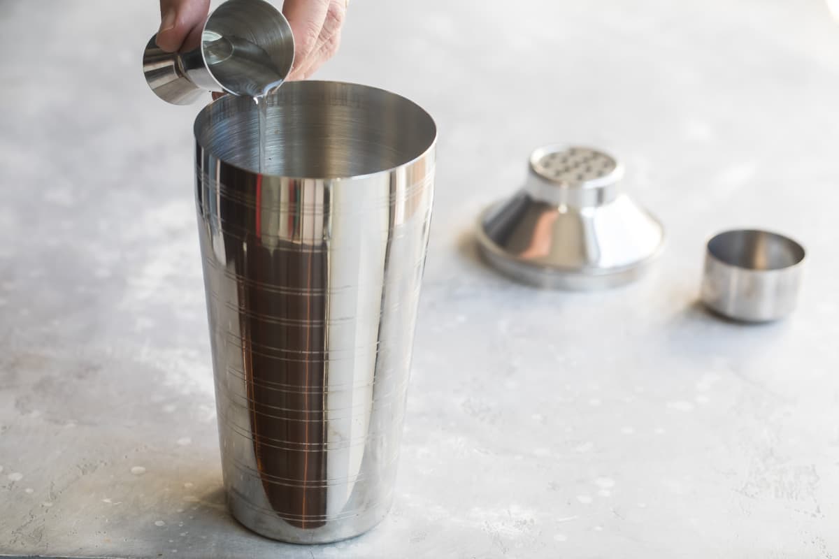 Liquor being poured into a martini shaker.