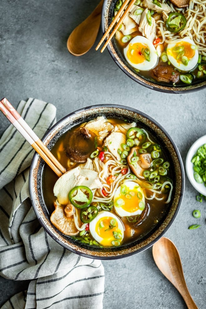 Chicken ramen in two bowls with chopsticks.