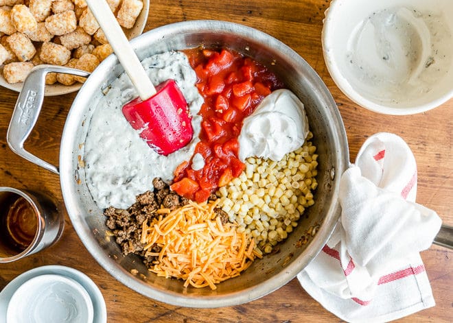 Cowboy casserole ingredients in a metal bowl before being mixed.