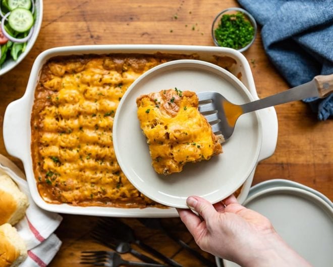 Cowboy Casserole being dished out of a baking pan.