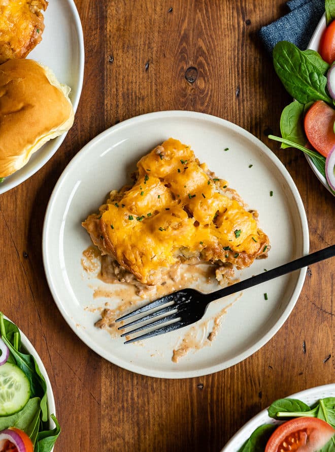 Cowboy casserole on a white round plate with a fork.