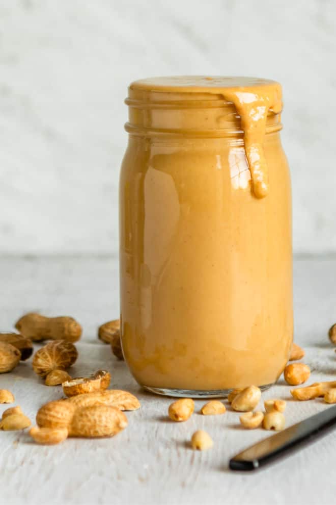 Homemade peanut butter in a clear jar.