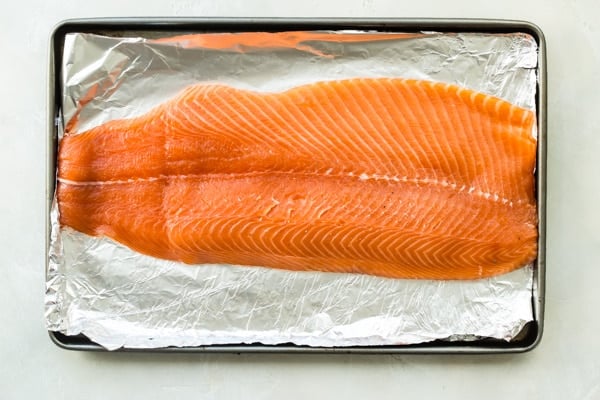 An overhead shot of salmon before being smoked set on foil.
