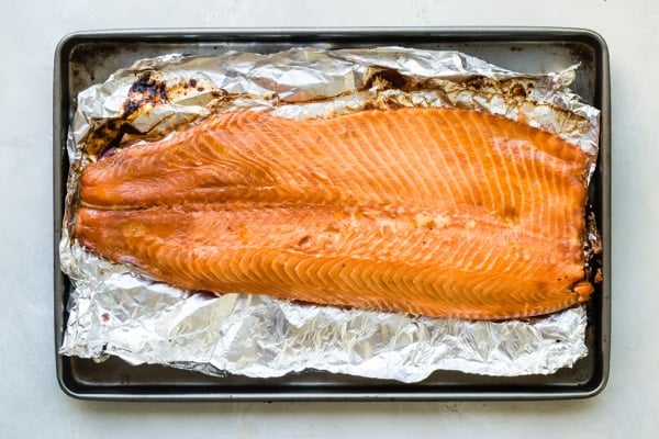 An overhead shot of smoked salmon out of the smoker on foil.