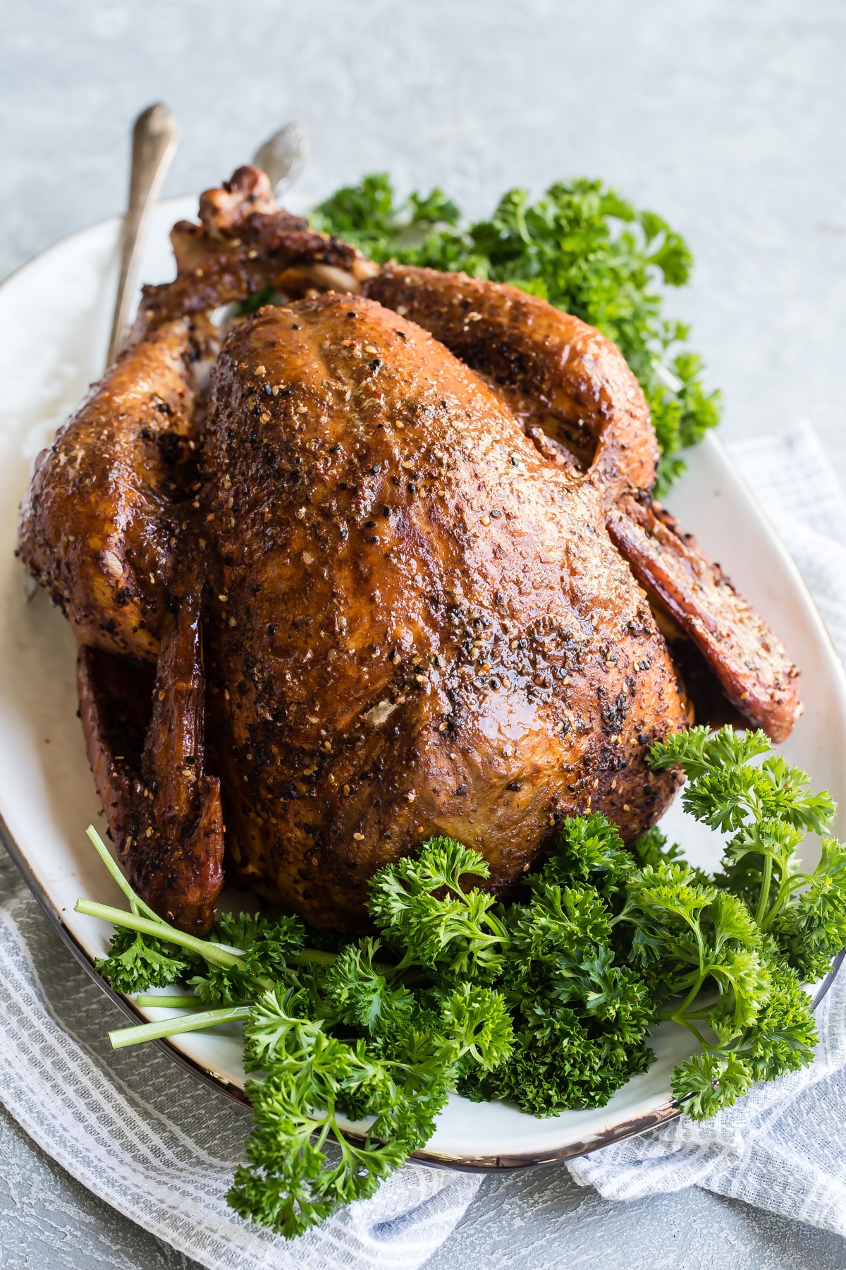 A whole smoked turkey on a platter.
