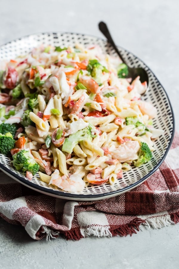 Seafood salad on a black and white platter.