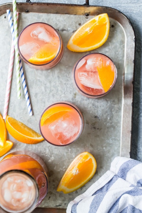 Mocktail juice blend in clear glasses on a silver tray.