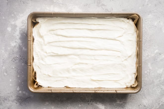 White filling in a tan baking pan.