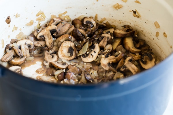 Cooked mushrooms in a blue pot.