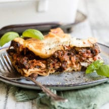 Vegetable lasagna on a blue plate.
