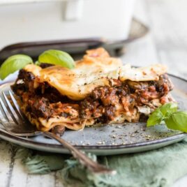 Vegetable lasagna on a blue plate.