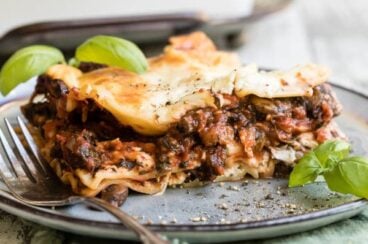Vegetable lasagna on a blue plate.