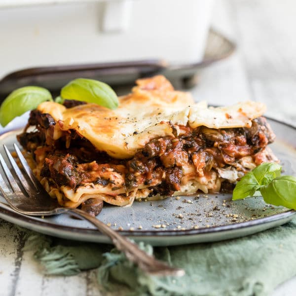 Vegetable lasagna on a blue plate.
