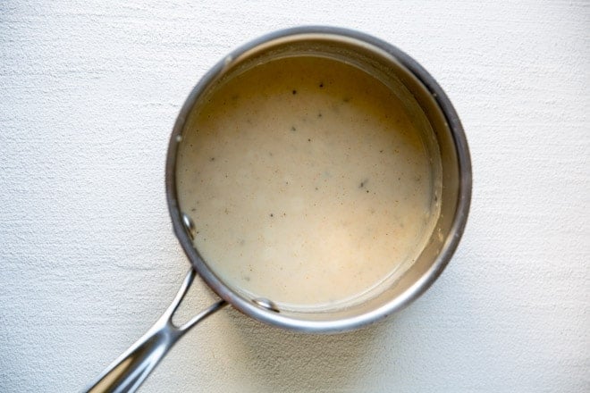 Condensed cream of chicken soup in a silver pot.