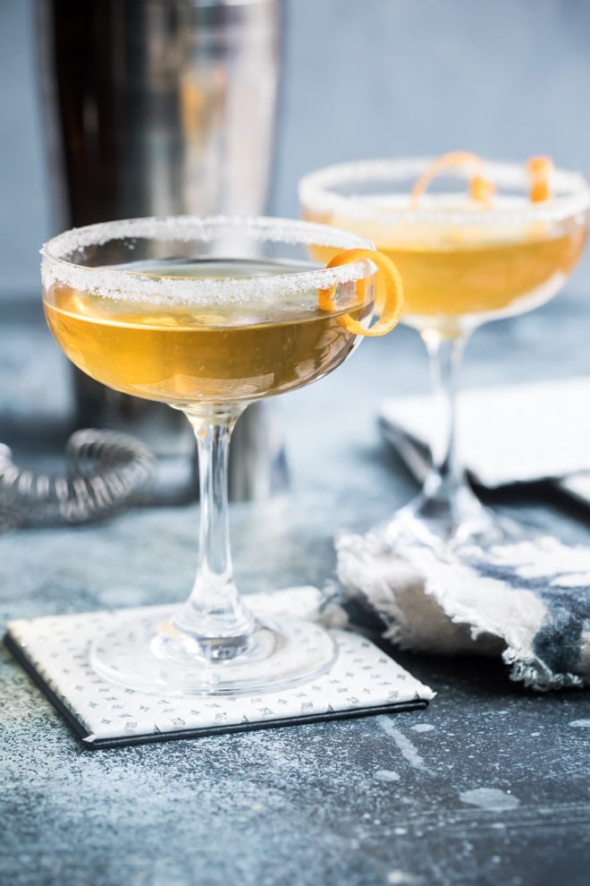 Sidecar cocktails in two clear stemmed glasses.