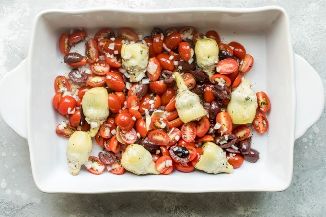 Roasted vegetables in a white baking dish.