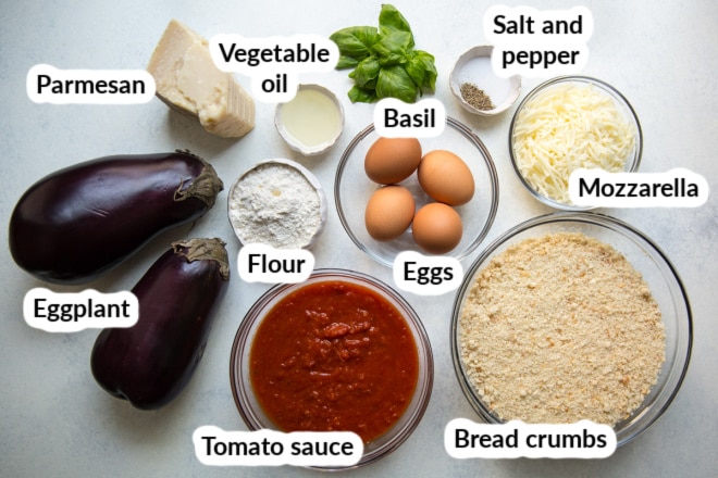 Labeled eggplant parmesan ingredients in bowls.