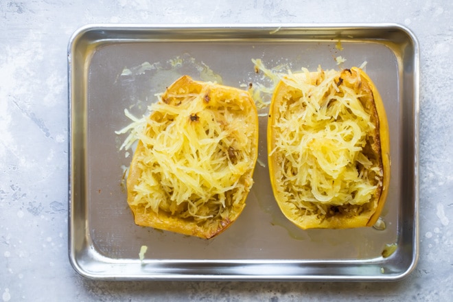 Spaghetti squash on a sliver baking sheet.