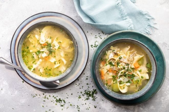 Leftover turkey noodle soup in a blue bowls.
