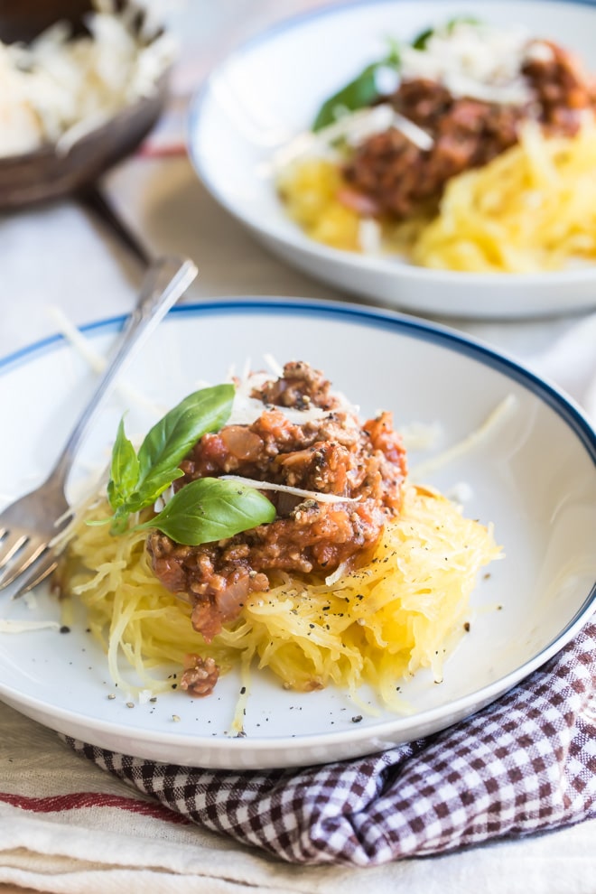 Spaghetti squash with homemade meat sauce on a white plate.
