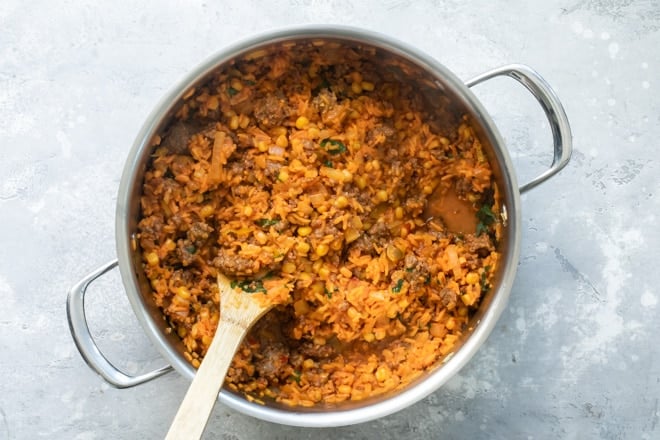One pot Puerto Rican rice in a silver pot.
