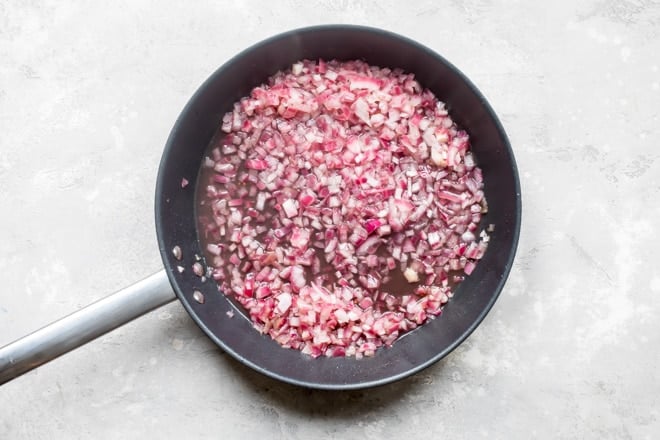 Hot bacon dressing in a black skillet.
