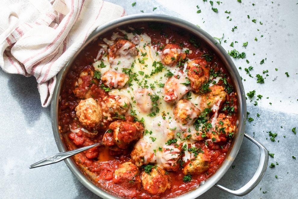 Chicken Parmesan meatballs in a silver pot.