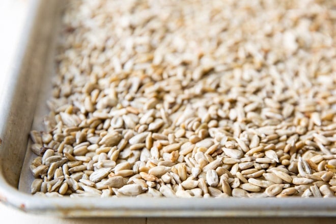Sunflower seeds on a baking sheet.