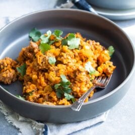 One pot puerto rican rice in a navy bowl.