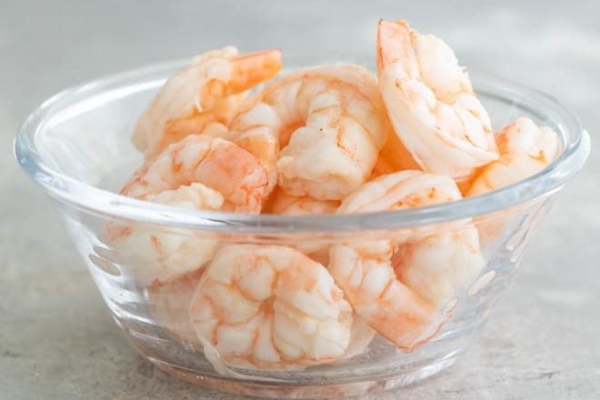 Learn how to poach shrimp in a flavorful broth with lemon, herbs, and peppercorns. This gentle cooking technique always results in perfectly tender, outrageously delicious shrimp for your favorite recipes.