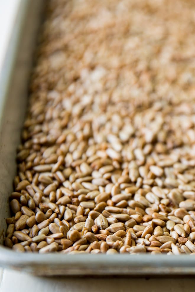 Toasted sunflower seeds on a baking pan.