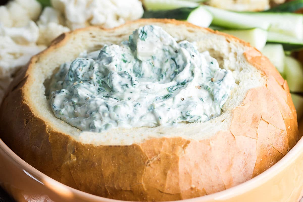 A bread bowl filled with Knorr Spinach Dip.