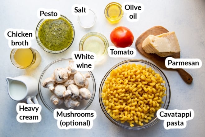 Labeled pesto cavatappi ingredients in bowls.