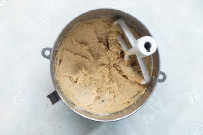 A mixing bowl with sugar mixed into the butter, creamed together.