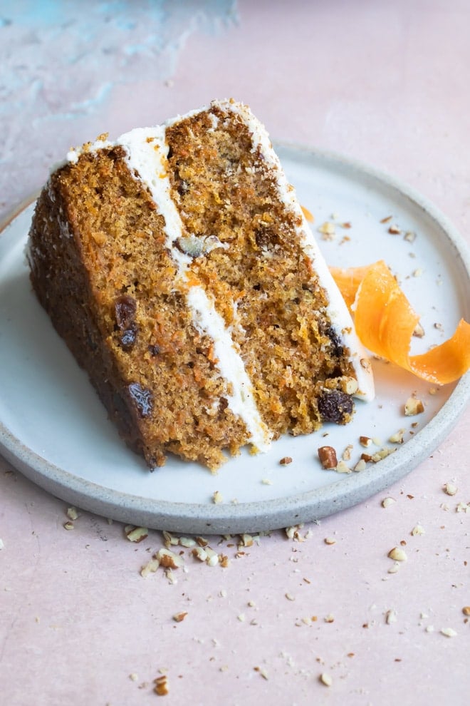 A slice of carrot cake on a blue plate.