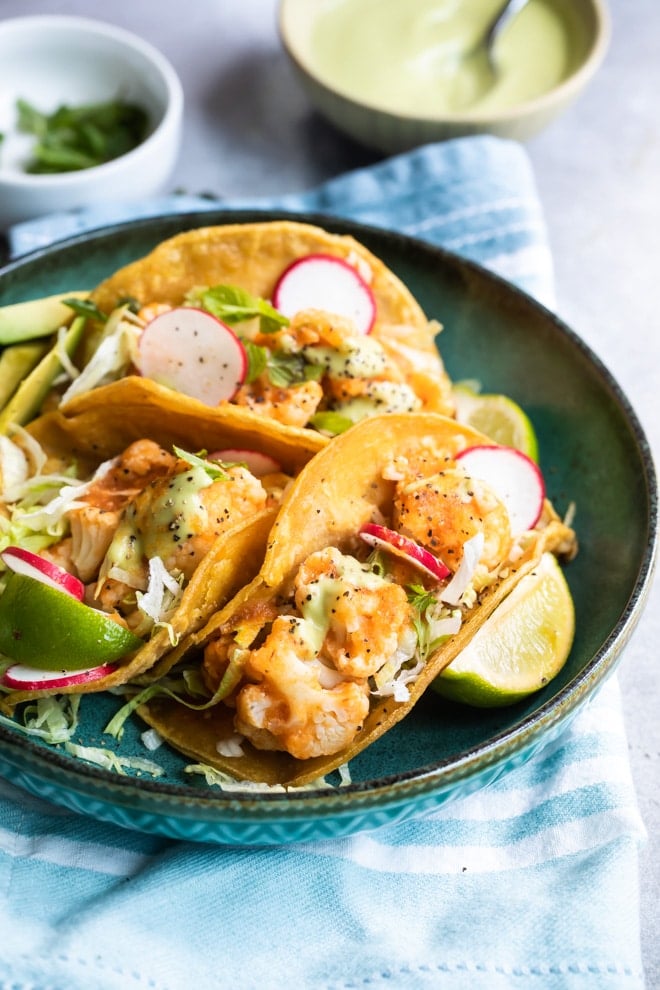 Cauliflower Tinga tacos on a blue plate.