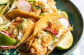 Cauliflower Tinga tacos on a blue plate.