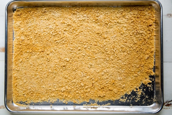 Breadcrumbs on a sliver baking sheet. 